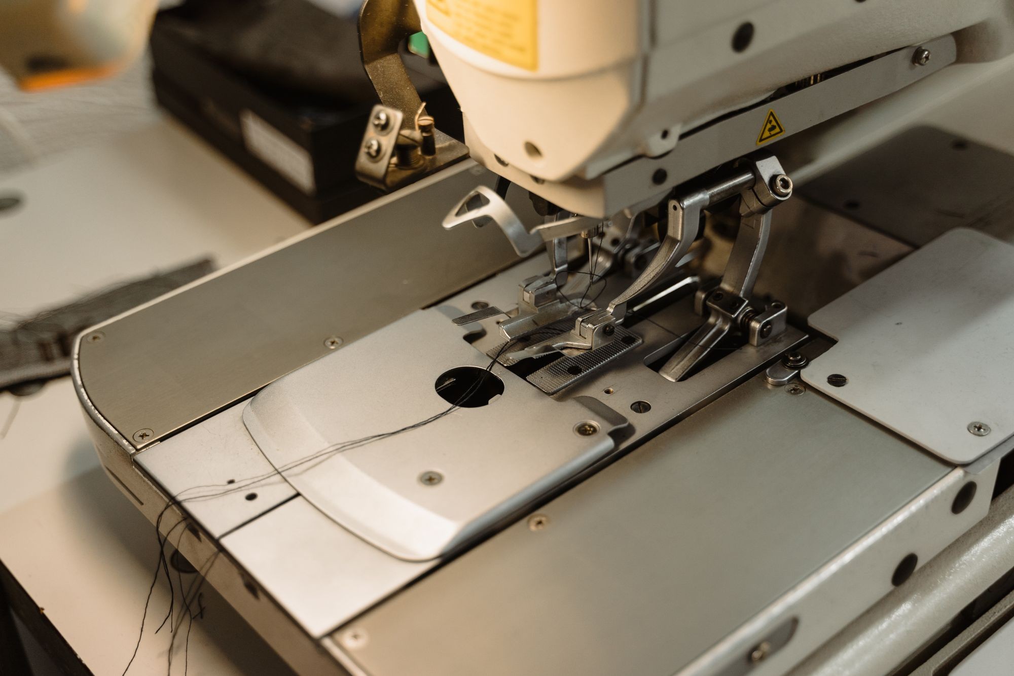 Industrial sewing machine stitching clothing fabric