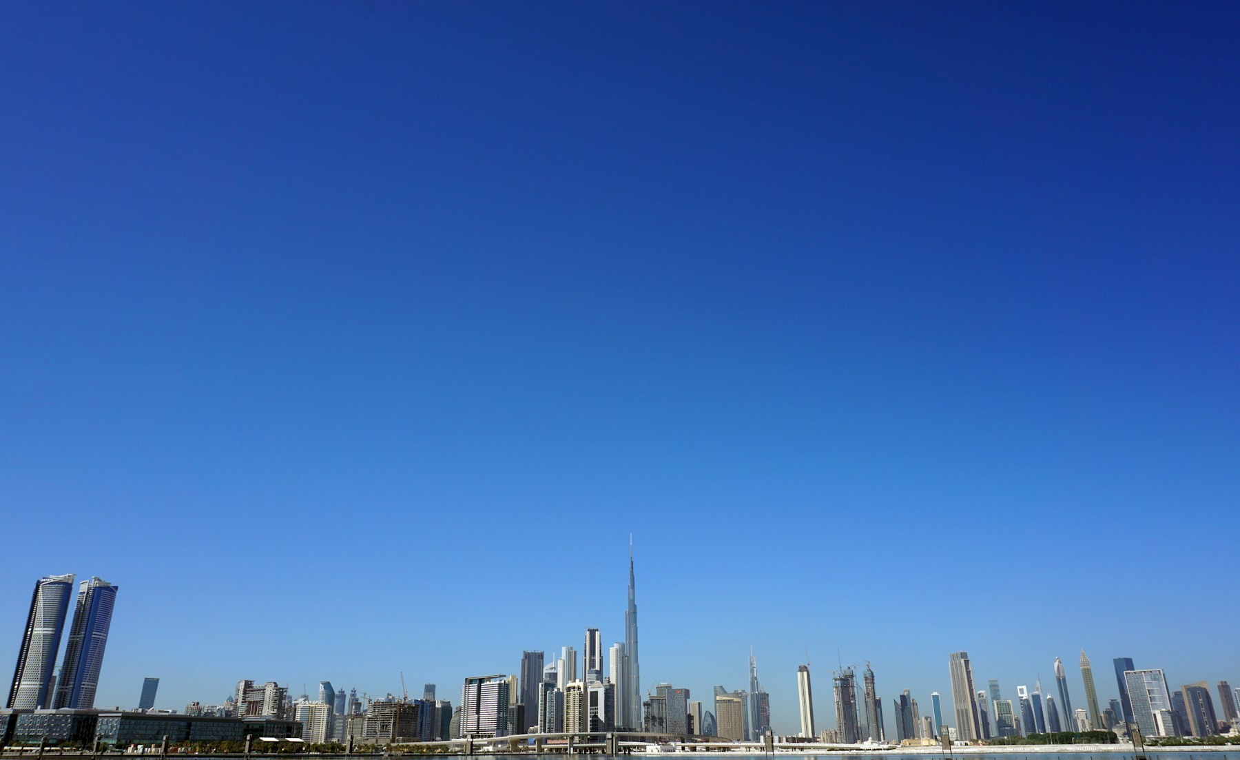 Dubai skyline and the Burj Khalifa under a clear blue sky